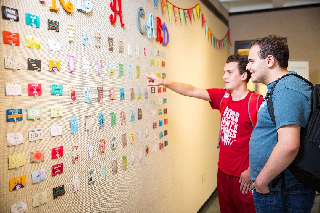 EMPOWER students Nick Lange (left) and Grant Alley discuss a wall display.